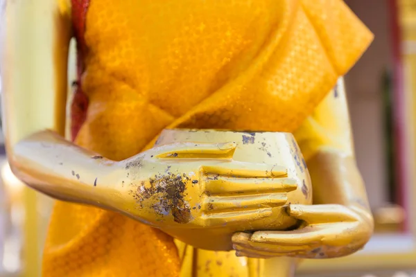 Hand of golden buddha statue holding alms bowl — Stock Photo, Image