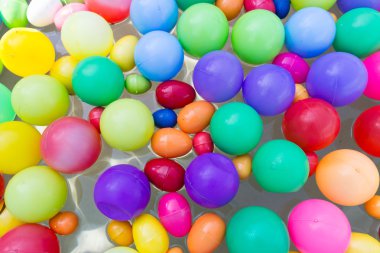 havuzda su üzerinde yüzen renkli plastik top 