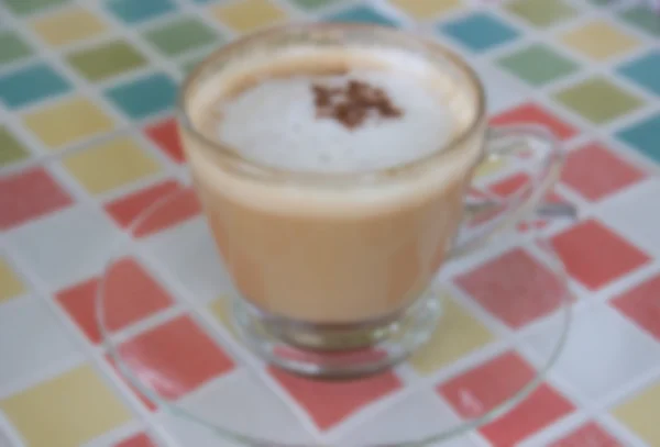 Blurry defocused hot cappuccino coffee with cinnamon topping for — Stock Photo, Image