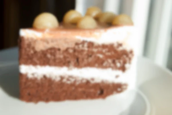 Размытый размытый шоколадный торт с Macadamia сверху для backgr — стоковое фото