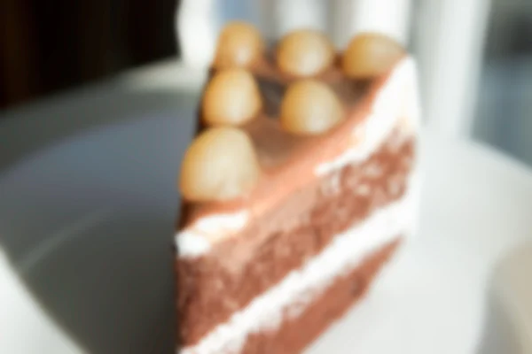 Torta de chocolate desenfocada borrosa con Macadamia en la parte superior para backgr — Foto de Stock