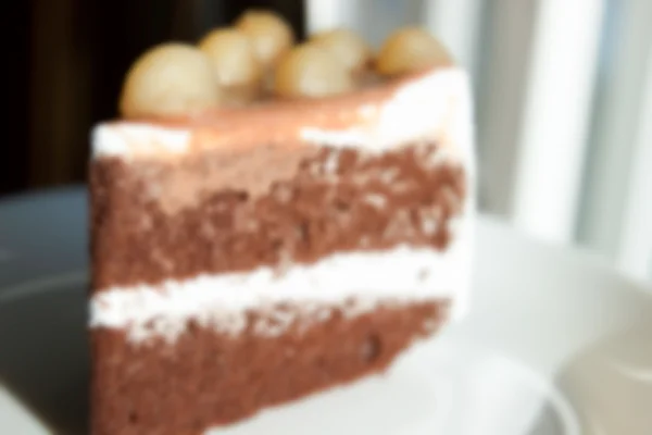 Verschwommene defokussierte Schokoladenkuchen mit Macadamia an der Spitze für Backgr — Stockfoto