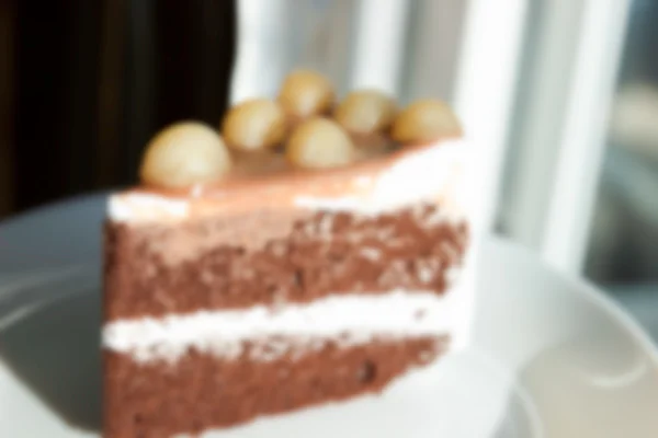 Verschwommene defokussierte Schokoladenkuchen mit Macadamia an der Spitze für Backgr — Stockfoto