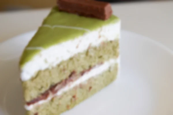 Zamazany obraz niewyraźne tortu zielonej herbaty z czerwonym bobowym ciastem świeckich — Zdjęcie stockowe