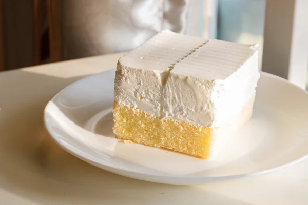 Butter cake with cream on top — Stock Photo, Image