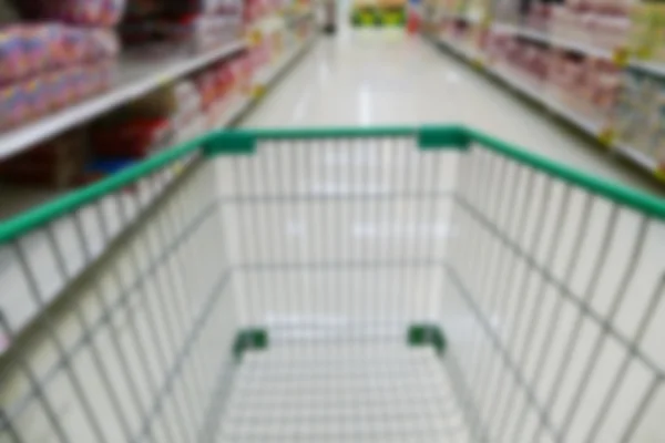 Cart in aisle of supermarket — Stock Photo, Image