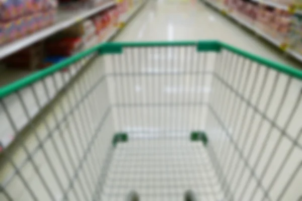 Cart in aisle of supermarket — Stock Photo, Image