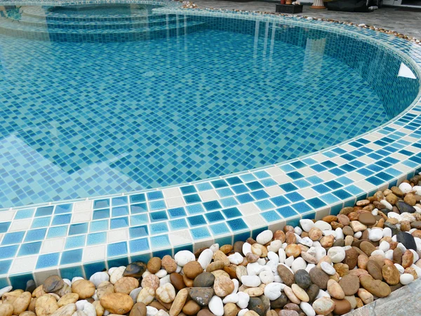 Stone on the edge of the swimming pool — Stock Photo, Image