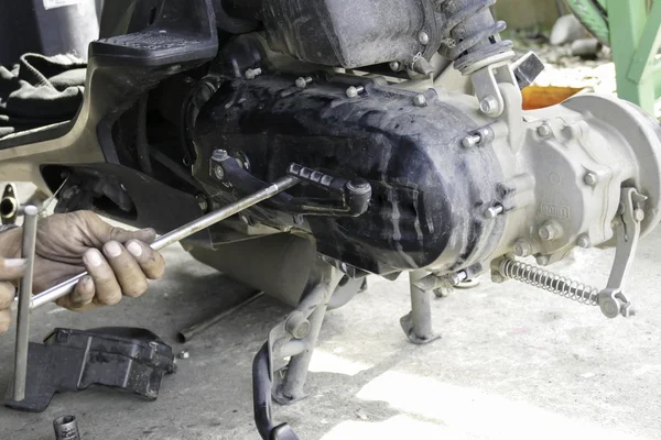 Механик проверяет шкив и ленту мотоцикла — стоковое фото