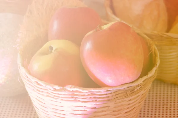 Apple in the basket with soft focus and color filter — Stock Photo, Image