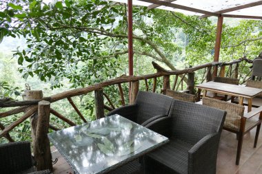 Rattan ve ahşap sandalye ve masa terasta