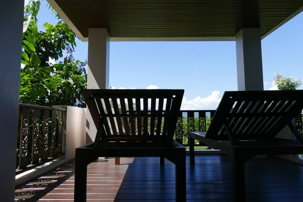 Wooden deckchair at the balcony with forest and sky view — Stock Photo, Image