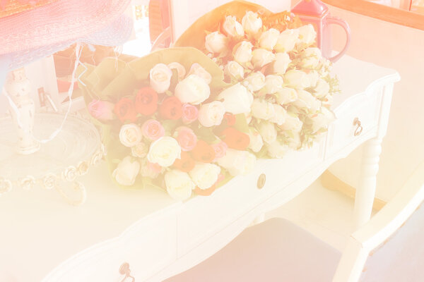 fake rose on white dressing table (color filter and soft focus)