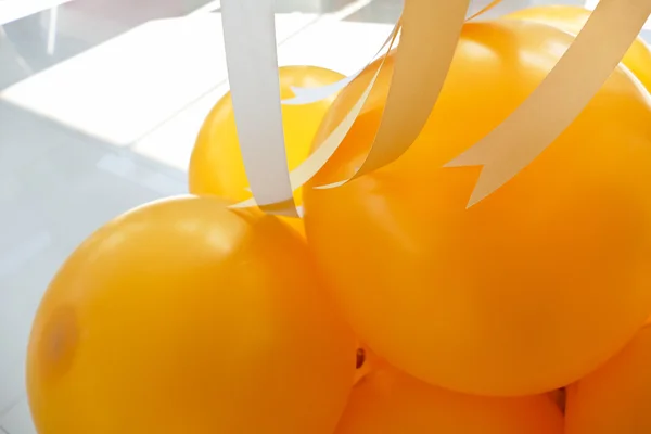 Yellow balloon and yellow and white ribbon — Stock Photo, Image