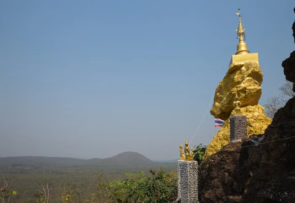 Golden buddhism pagoda on big stone — Stock Photo, Image