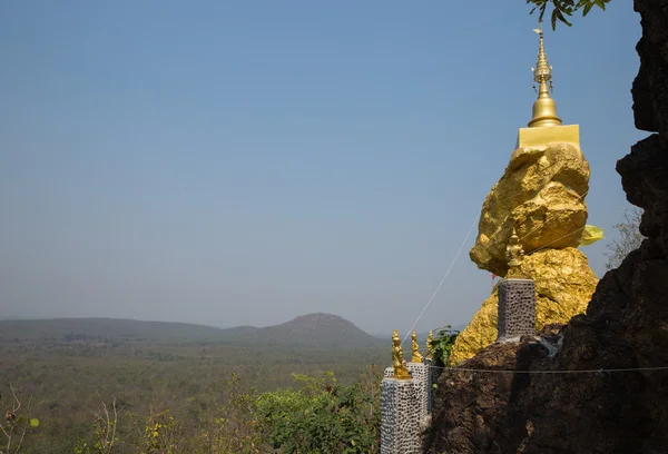 Golden buddhism pagoda on big stone — Stock Photo, Image