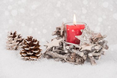 Yanan Mum ve çam koni karda