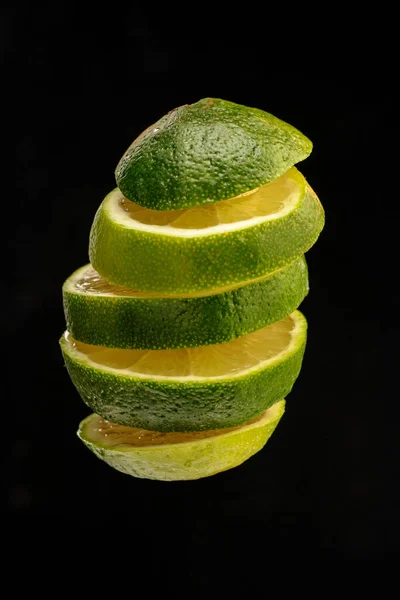 Ripe Lime Cut Slices Tossed Air Isolated Black Background Food — Stock Photo, Image