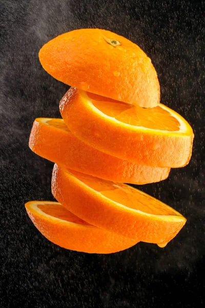 Ripe Orange Cut Slices Tossed Air Isolated Black Background Food — Stock Photo, Image