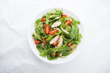 Fresh salad with chicken, tomato and greens (spinach, arugula)