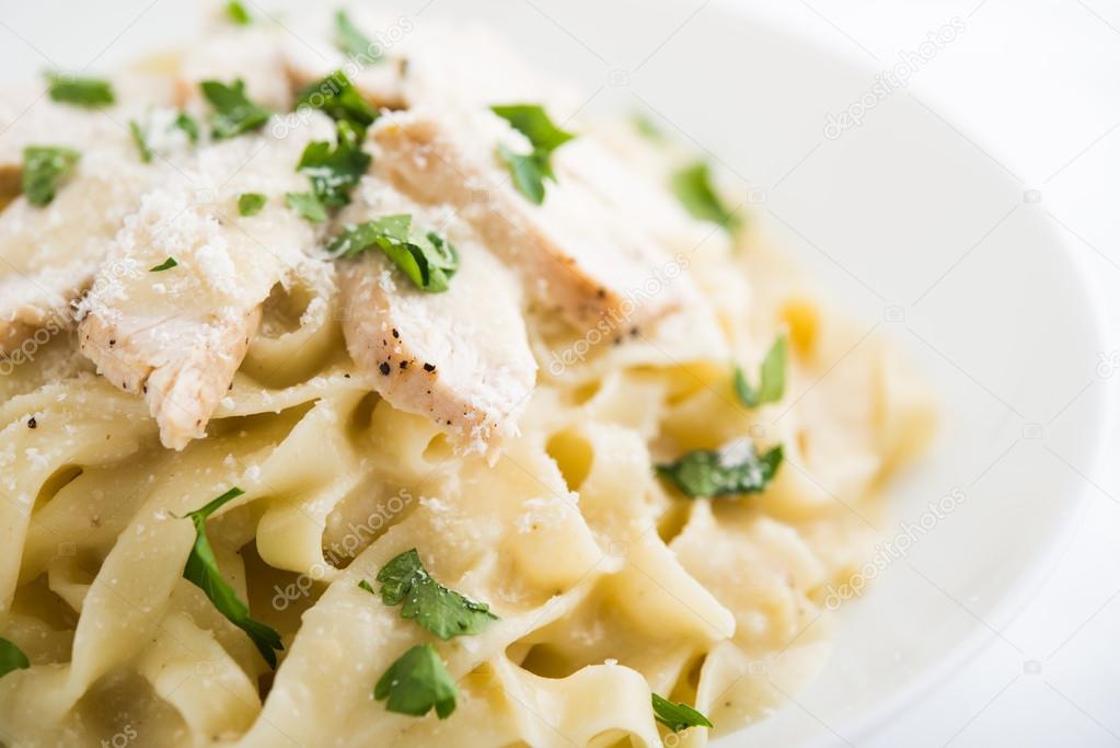 Pasta fettuccine alfredo with chicken, parmesan and parsley