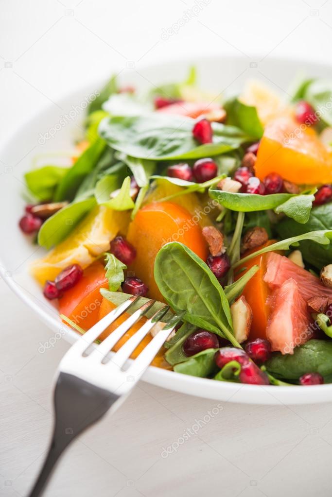Fresh salad with fruits and greens