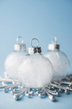 White xmas ornaments on light blue background. Merry christmas card. Winter holiday theme. Happy New Year.