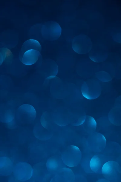 Unfocused abstract dark blue glitter bokeh holiday background. Winter xmas holidays. Christmas. — Stock Photo, Image