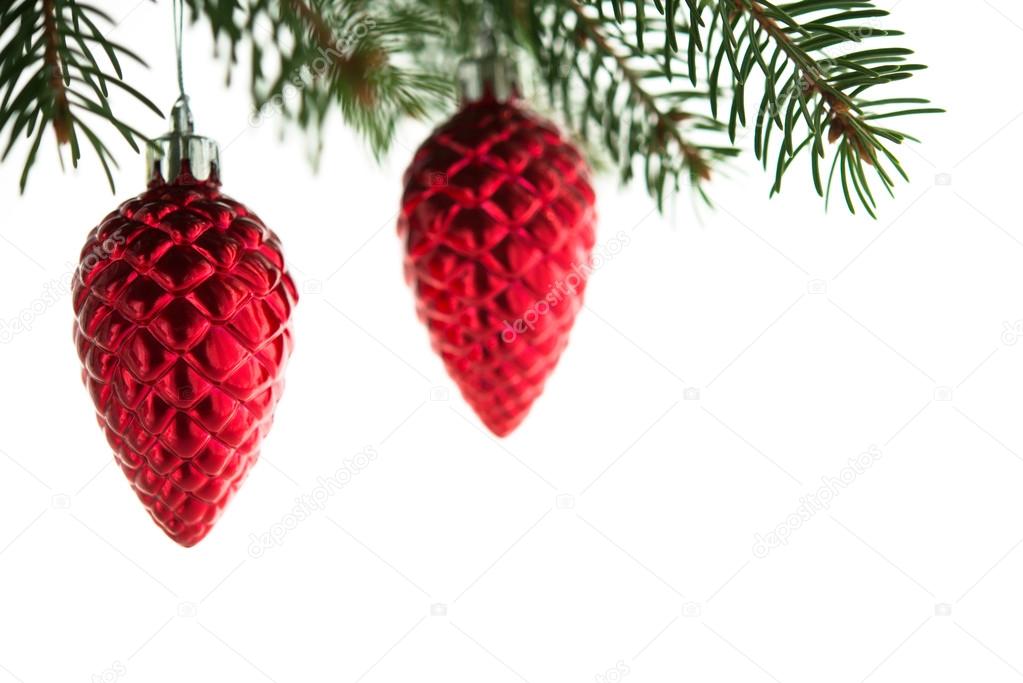 Red christmas ornaments (cones) on the xmas tree on white background isolated. Winter holiday theme.