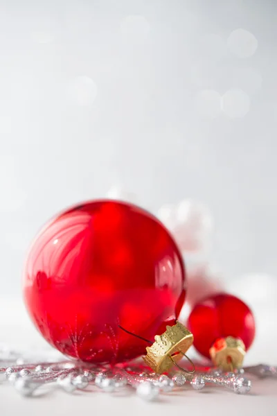 Red xmas ornaments on glitter holiday background — Stock Photo, Image