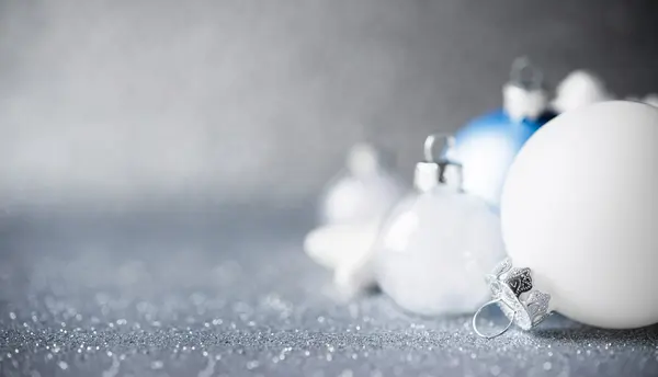 Blue, silver and white xmas ornaments on glitter holiday background — Stock Photo, Image