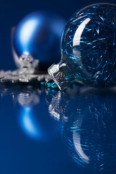 Blue and silver xmas ornaments on dark blue background