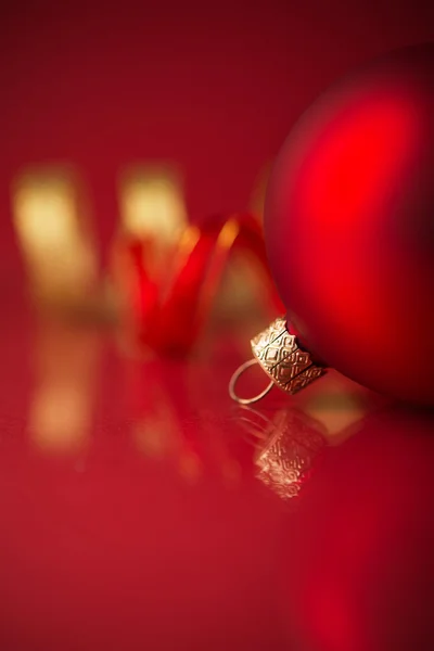 Red and golden christmas ornaments on red background with copy space. Xmas holiday theme. — Stock Photo, Image