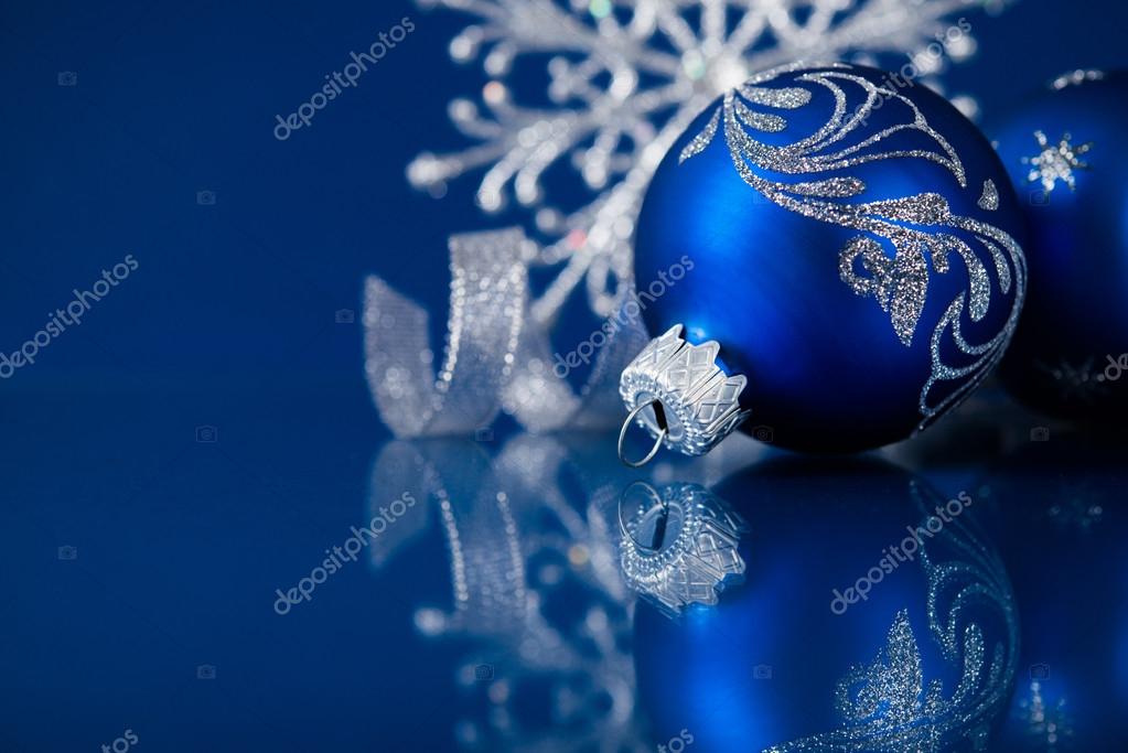 Blue and silver christmas ornaments on dark blue xmas background with