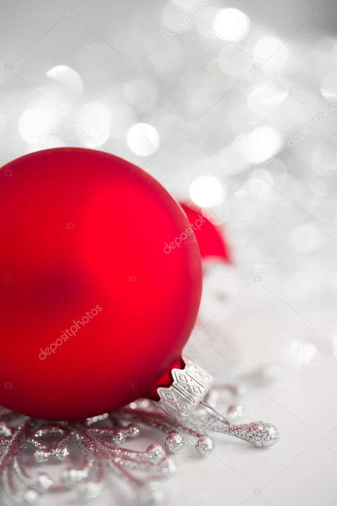 Red and silver xmas ornaments on bright holiday background. Merry christmas!