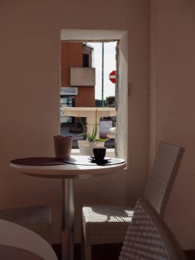 Yuvarlak Masa Üzerinde Siyah Kahve Kupası Pencere manzaralı Porto San Paolo, Sardunya, İtalya