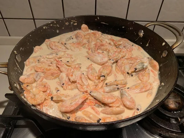 Soslu karides. Kızartma tavasında karides olan bir tabak. Baharatlı deniz ürünleri pişiriyorum..