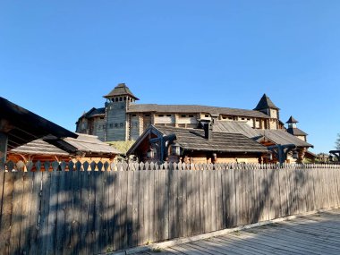 Gökyüzüne karşı tahta kale duvarı. Yüksek duvarları olan ortaçağ kalesi. Eski bir şehir tarzında ahşap döşeme. Park 