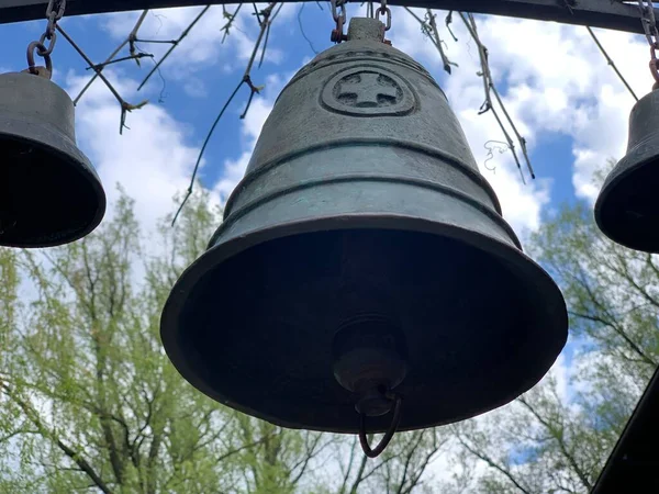 Church bell against the blue sky. Ancient bells in the courtyard of the old castle. Bell tower of an old European church.