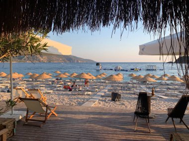 Kumsalda kumsal tatili. Şemsiyeli ve güneşli deniz plajı. Akdeniz 'de yaz tatili. Türkiye 'de Mavi Loguna, Oludeniz - Fethia, 10 Temmuz 2021