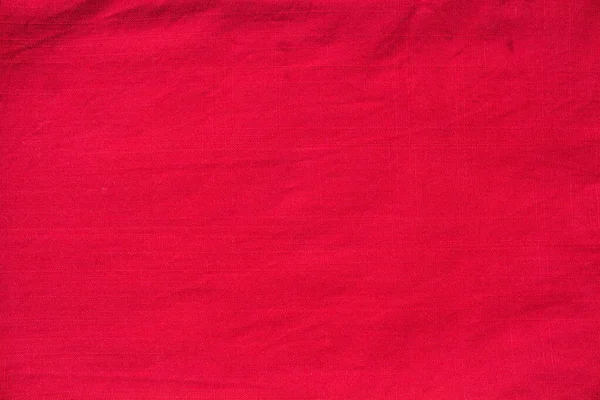 La textura de tela densa de lino rojo de color rojo brillante de cerca. Textura abstracta fondo rojo, vista superior — Foto de Stock