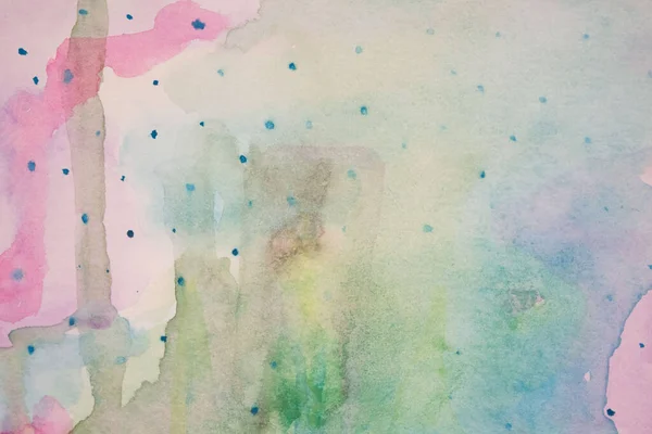 Abstract watercolor. Stains of pink, blue, green, yellow watercolor stains flowing into each other. Watercolor paper texture.