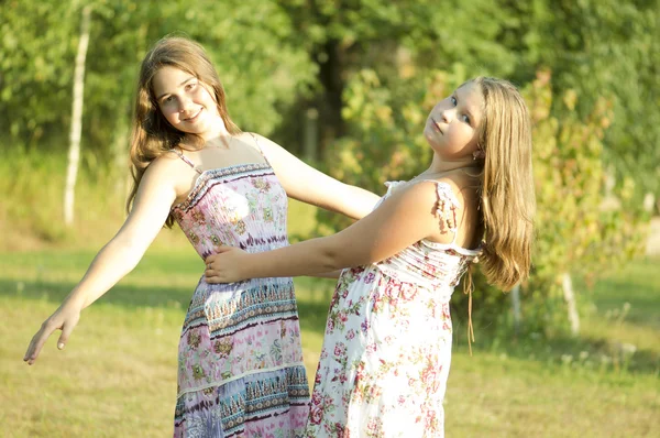 Dwie dziewczyny tańczy w ogrodzie. — Zdjęcie stockowe