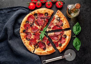 Akdeniz pizzası, salamlı sosis, mozarella, zeytin, Provencal otlar, arka planda imzalı domates sosu.