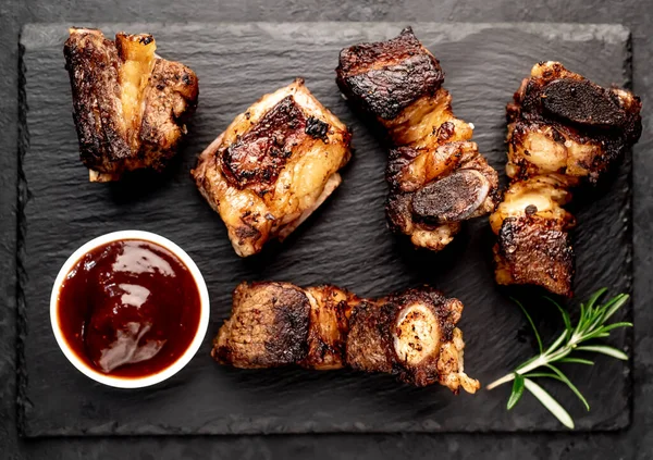 grilled beef ribs on a stone background