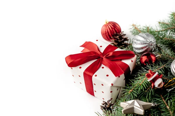 白い背景に白いギフトボックスに赤いリボンとクリスマスの構図モミの枝 おもちゃ おめでとうございます — ストック写真