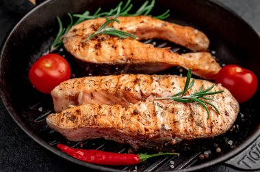 İki kişilik yemek, arka planda somon bifteği..