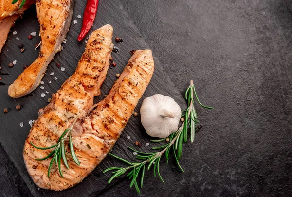 İki kişilik yemek, arka planda somon bifteği..