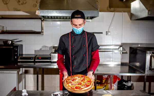 chef in uniform cooking with kitchen in the restaurant