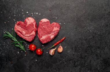 Siyah arka planda baharatlı dilimlenmiş biftek. 